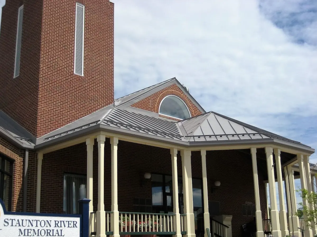 Skilled roofing craftsmen working on a residential roof in Greenville Memorial Hospital